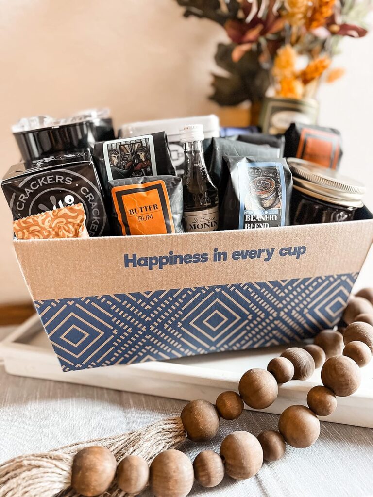 Specialty coffee gift basket with Coffee Beanery mug and 9 sample bags of medium roast ground coffee in assorted flavors.